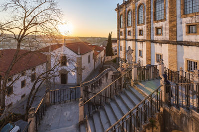 Residential buildings against sky during sunset