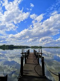 Pier on lake against sky