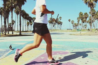 Low section of woman jogging at venice beach