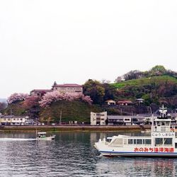 Boats in river with buildings in background