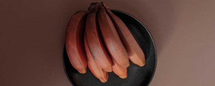 Bunch of bananas on plate over table