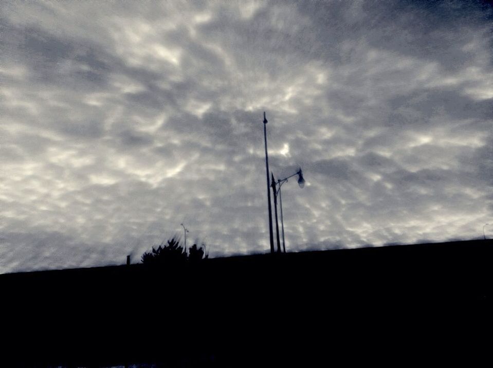 sky, silhouette, low angle view, cloud - sky, cloudy, cloud, street light, tranquility, nature, tree, dusk, overcast, beauty in nature, tranquil scene, outdoors, pole, scenics, weather, lighting equipment, no people