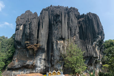 Low angle view of rock formations against sky