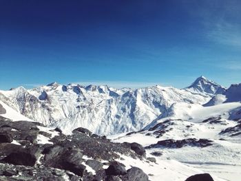Scenic view of snow covered mountains against sky