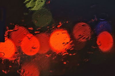 Close-up of wet illuminated water at night