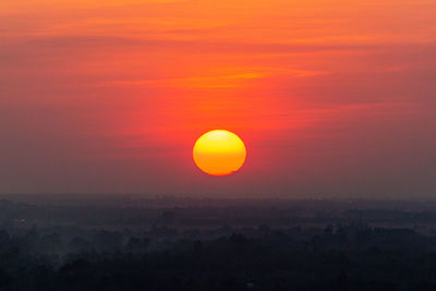 Scenic view of silhouette landscape against orange sky