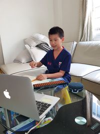 Full length of boy using mobile phone