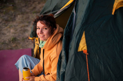 Portrait of a smiling young woman in tent