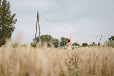 Woman on field against sky