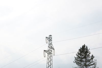 Low angle view of electricity pylon against sky