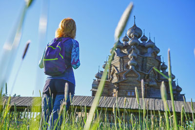Rear view of woman against blue sky