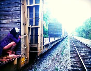 Woman standing by railing