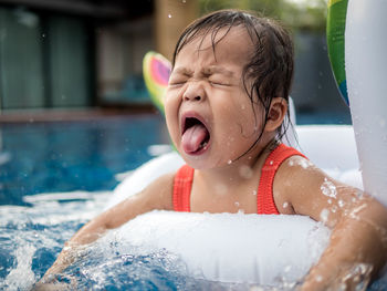 Close-up of cute girl with eyes closed in inflatable ring