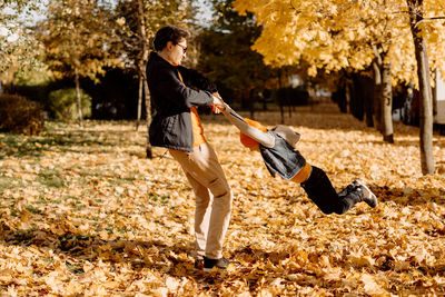 Full length of young woman exercising in park