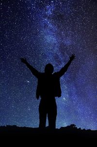 Silhouette man standing against sky at night