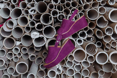 Purple shoes hanging from pipes