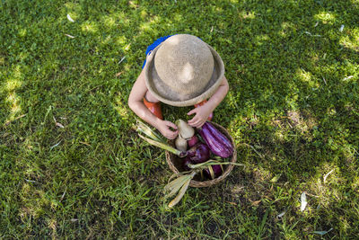 High angle view of girl wearing hat on field