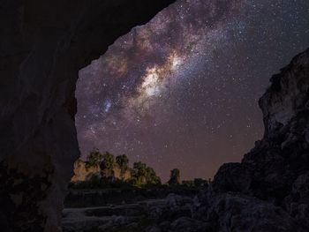 Rock formations against sky at night