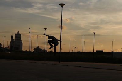 Silhouette of city street during sunset