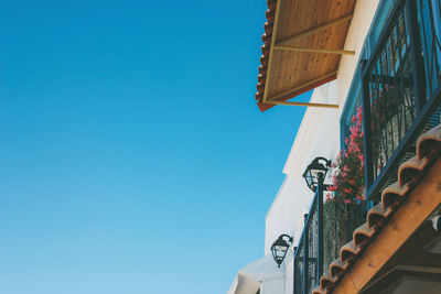 Beautiful roof facade of european cafe on the blue sky background, copy space