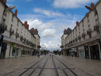 Street amidst buildings in city against sky