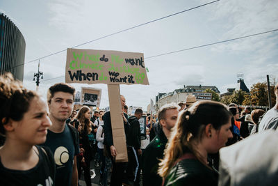 People on street in city against sky