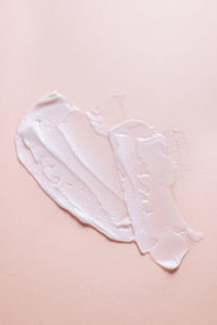 High angle view of wet pink over white background