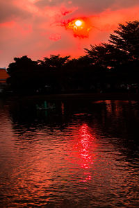 Scenic view of lake against orange sky