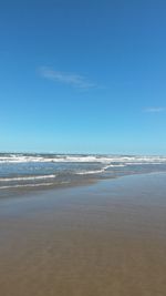 Scenic view of sea against blue sky