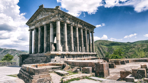 Ruins of temple against cloudy sky