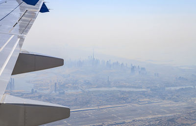 Cropped image of airplane wing against sky