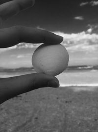 Close-up of hand holding pebbles