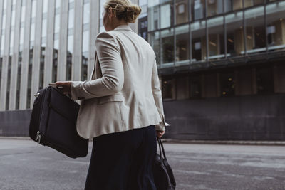 Rear view of woman standing in city