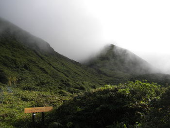 Low angle view of mountains in foggy weather