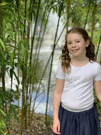 Portrait of a smiling girl against plants