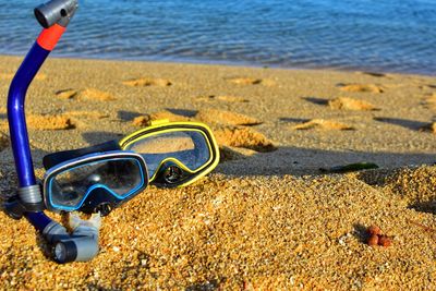 High angle view of sunglasses on beach