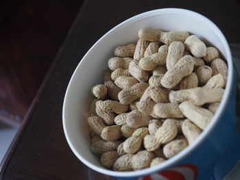 A cup of roasted peanuts close up details