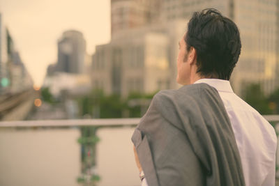 Rear view of man looking at city