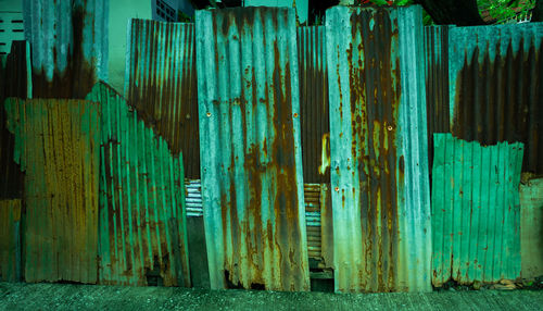 Full frame shot of old metallic structure against blue wall