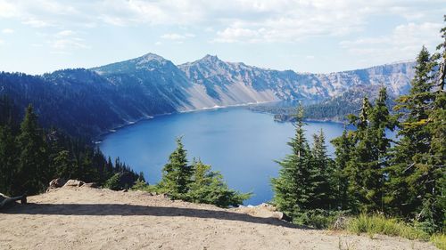 Scenic view of lake surrounded by mountains