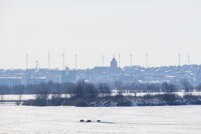 Scenic view of frozen river against clear sky