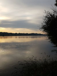 Scenic view of lake against sky at sunset