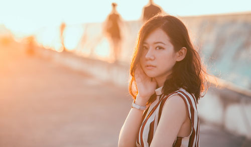 Portrait of beautiful young woman standing outdoors