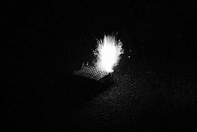 Low angle view of lit lamp at night