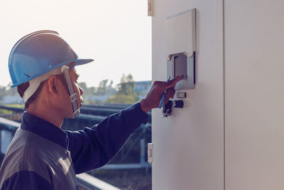 Male engineer checking meter