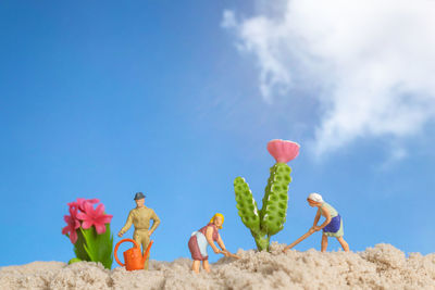 Low angle view of people on beach against sky