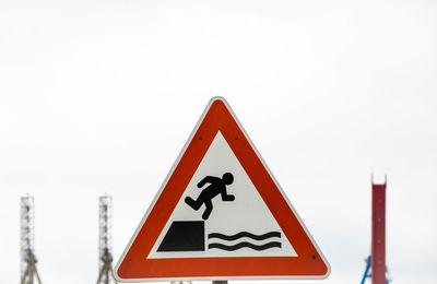 Close-up of road sign against clear sky