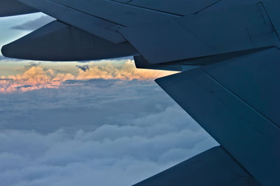 Airplane flying over cloudscape against sky