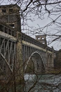 Low angle view of arch bridge against sky