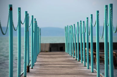 Close-up of wooden jetty at beach against sky